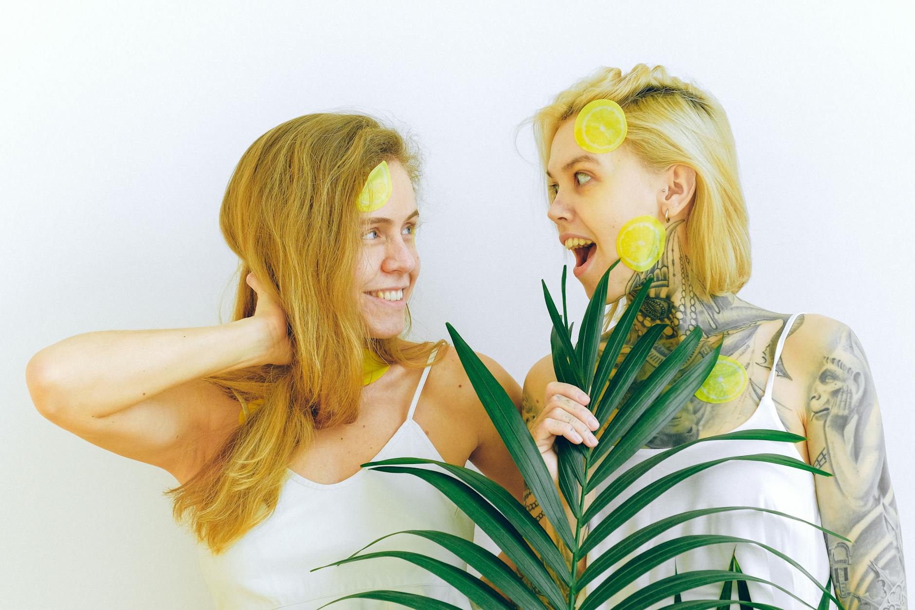 Two women smiling together indoors, expressing comfort and connection