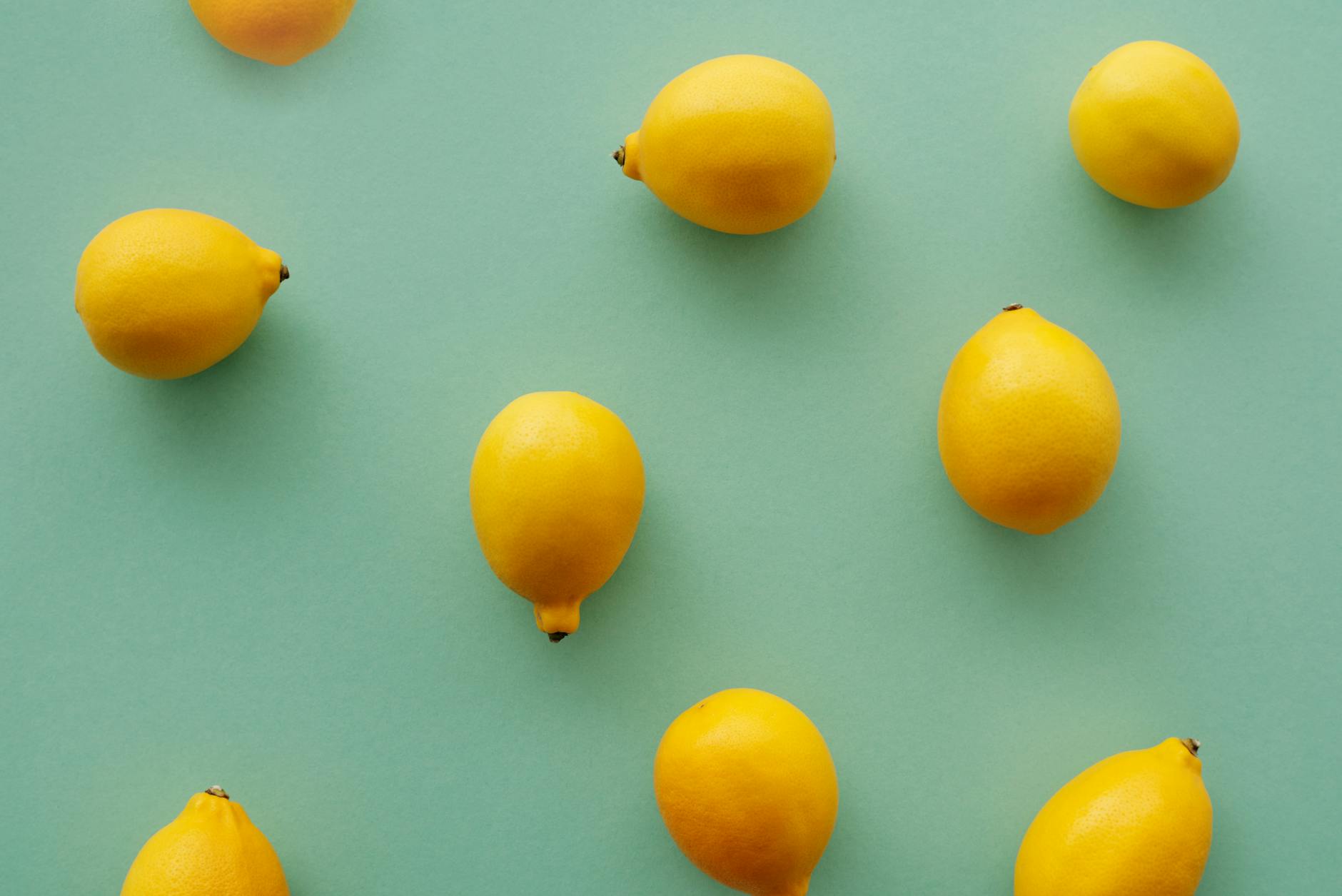 Fresh lemons on a pastel background symbolizing natural, skin-conscious sexual wellness
