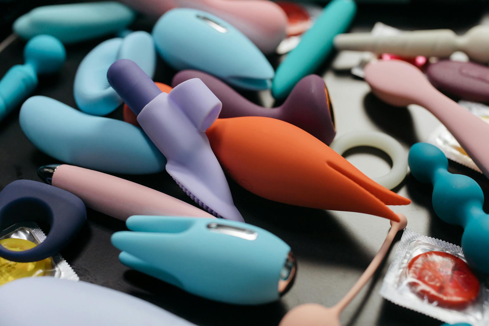 Close-up of colorful vibrators and pleasure products showcasing different textures and designs.