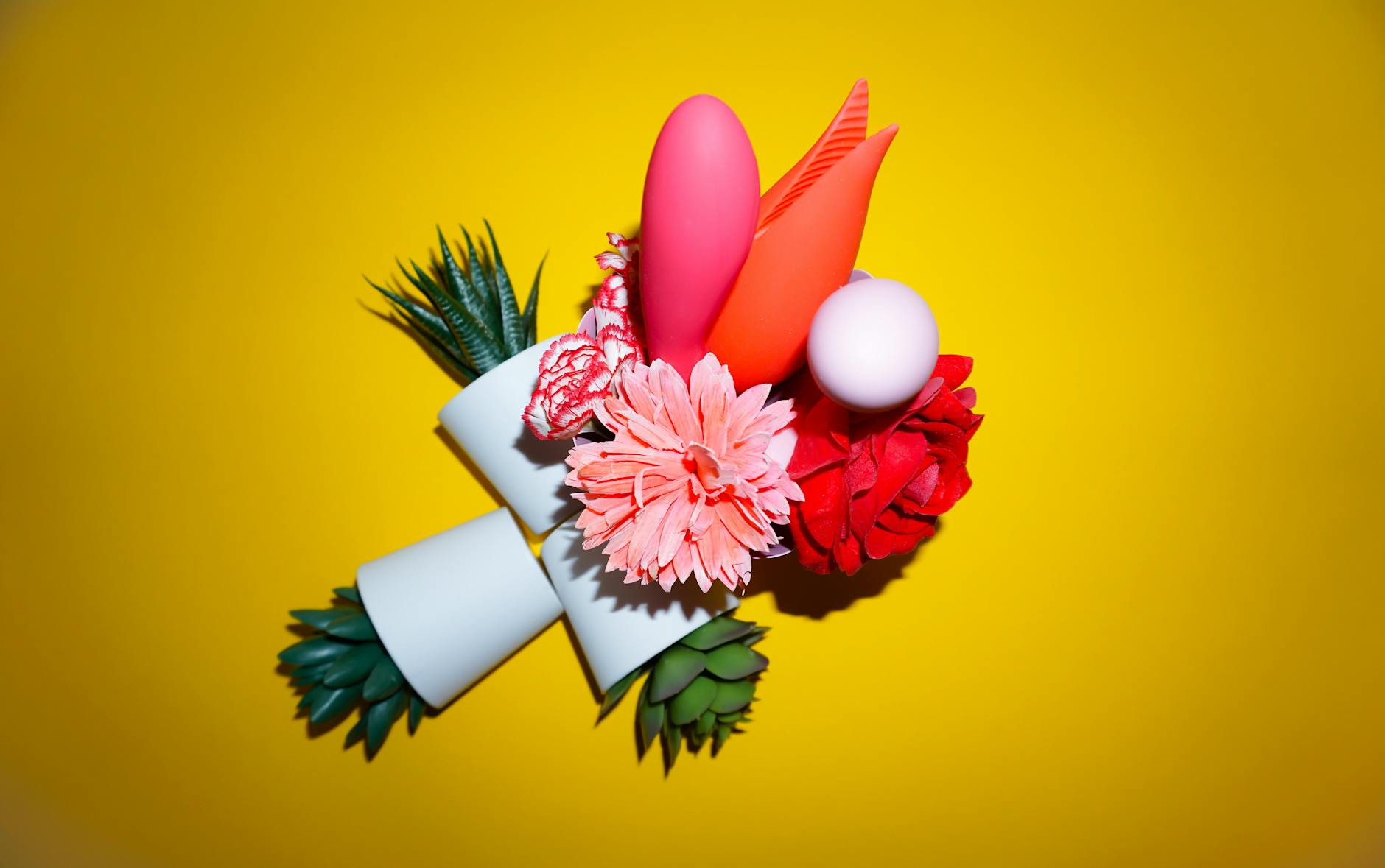 Fresh lemons on a white plate against a vibrant yellow background, symbolizing the lemon vibrator product line.