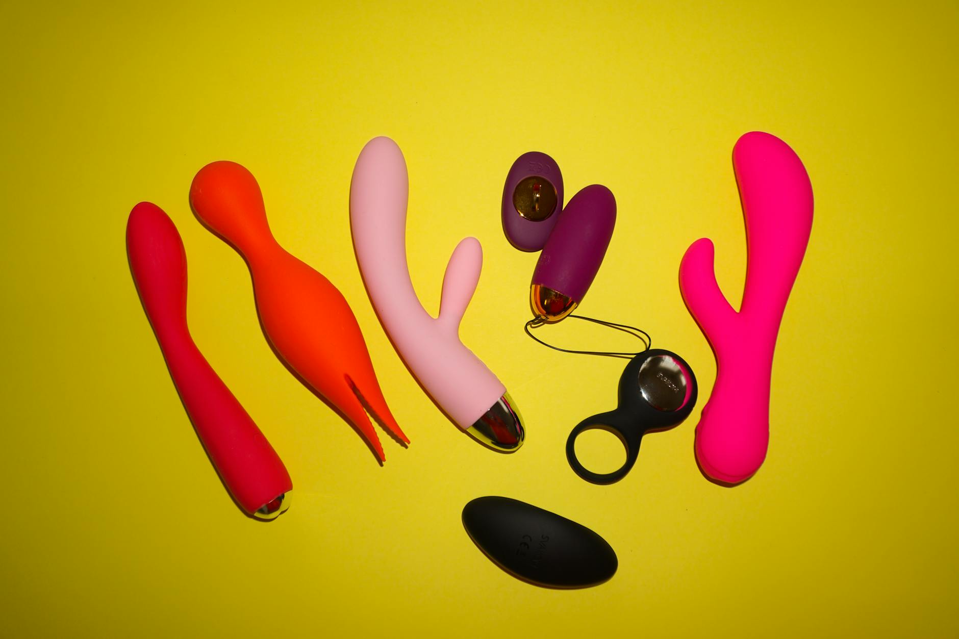 Sleek teal clitoral vibrator on white silk fabric, symbolizing calm and safe solo pleasure